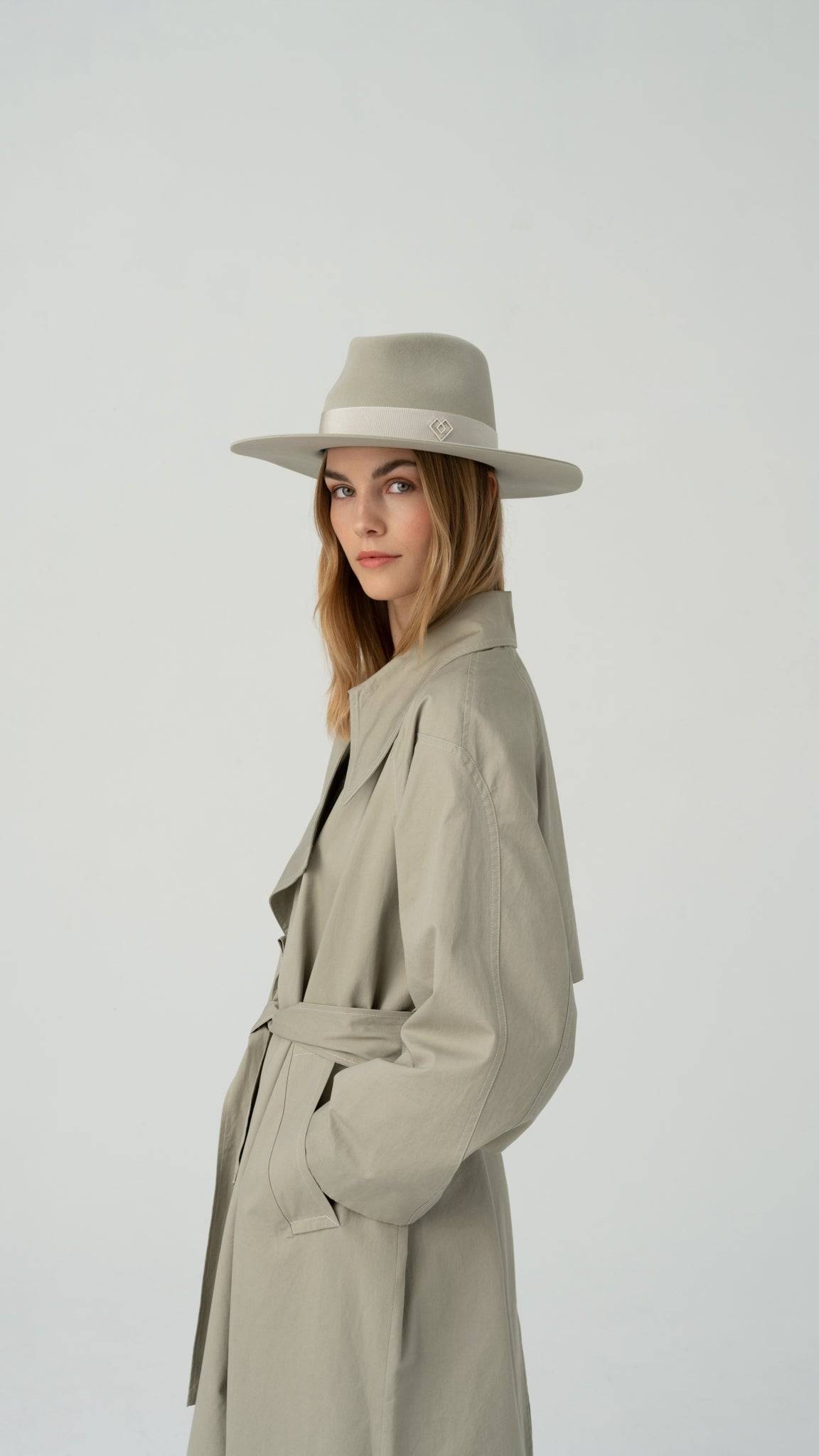 Side profile of the Monogram-embellished fedora hat, highlighting its premium rabbit fur felt construction and elegant grey ribbon trim.