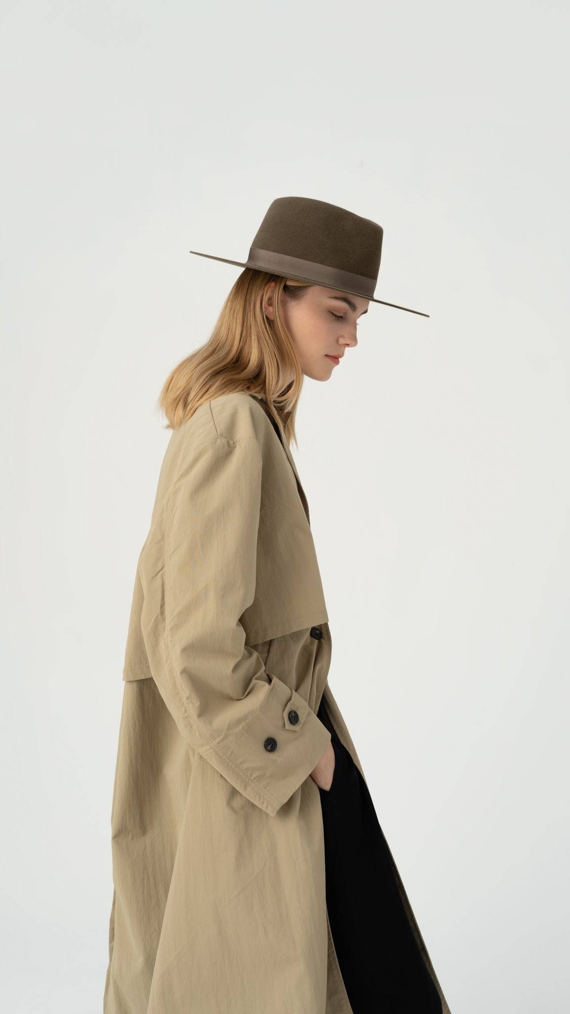 Pecan fedora hat styled with a beige trench coat, offering a refined and modern look. A perfect choice for fashion-forward individuals seeking classic appeal.
