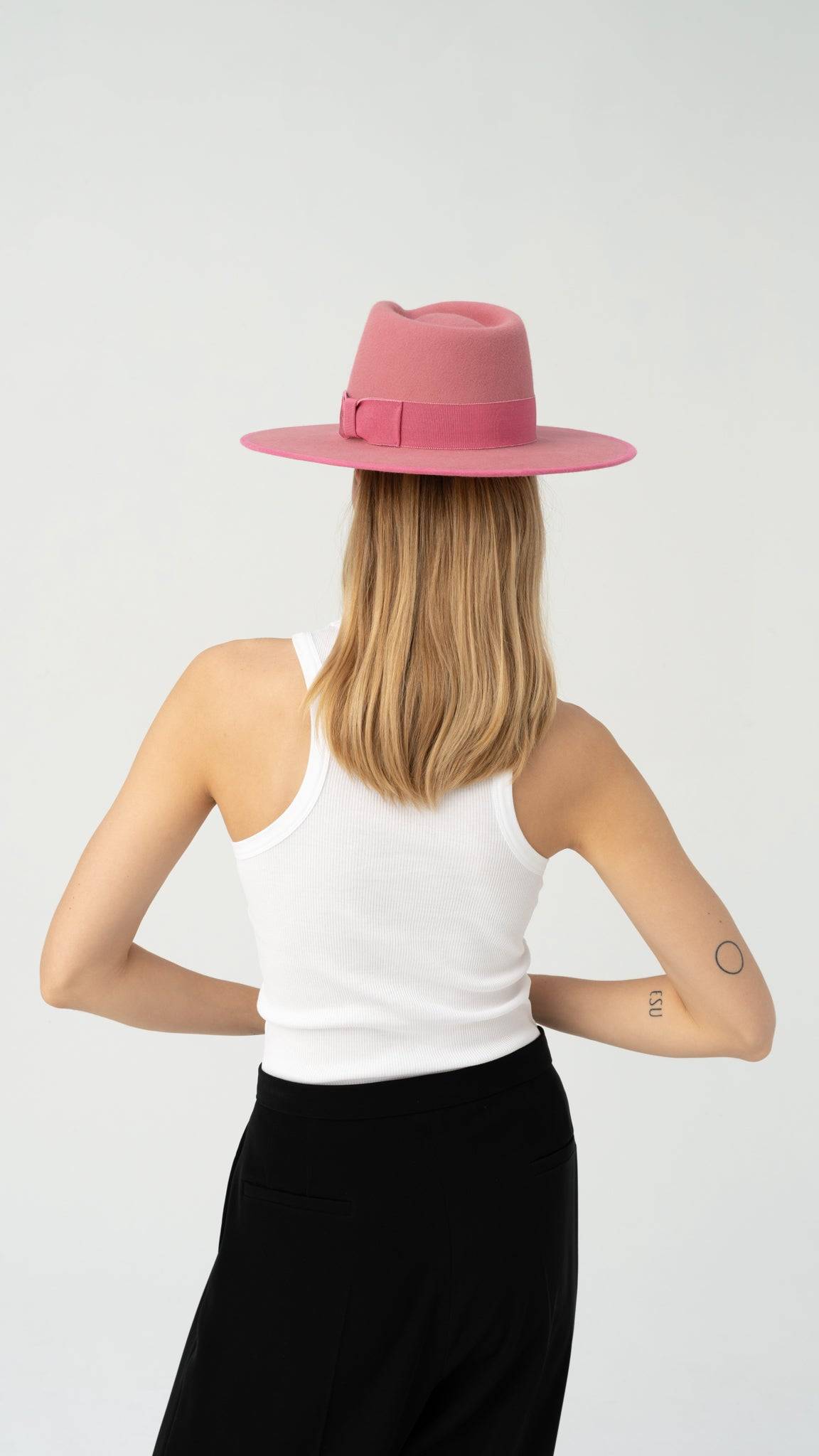 Back view of the dusty pink Monogram Fedora Hat, featuring a structured design and bow ribbon detail. A sophisticated handcrafted fashion statement.