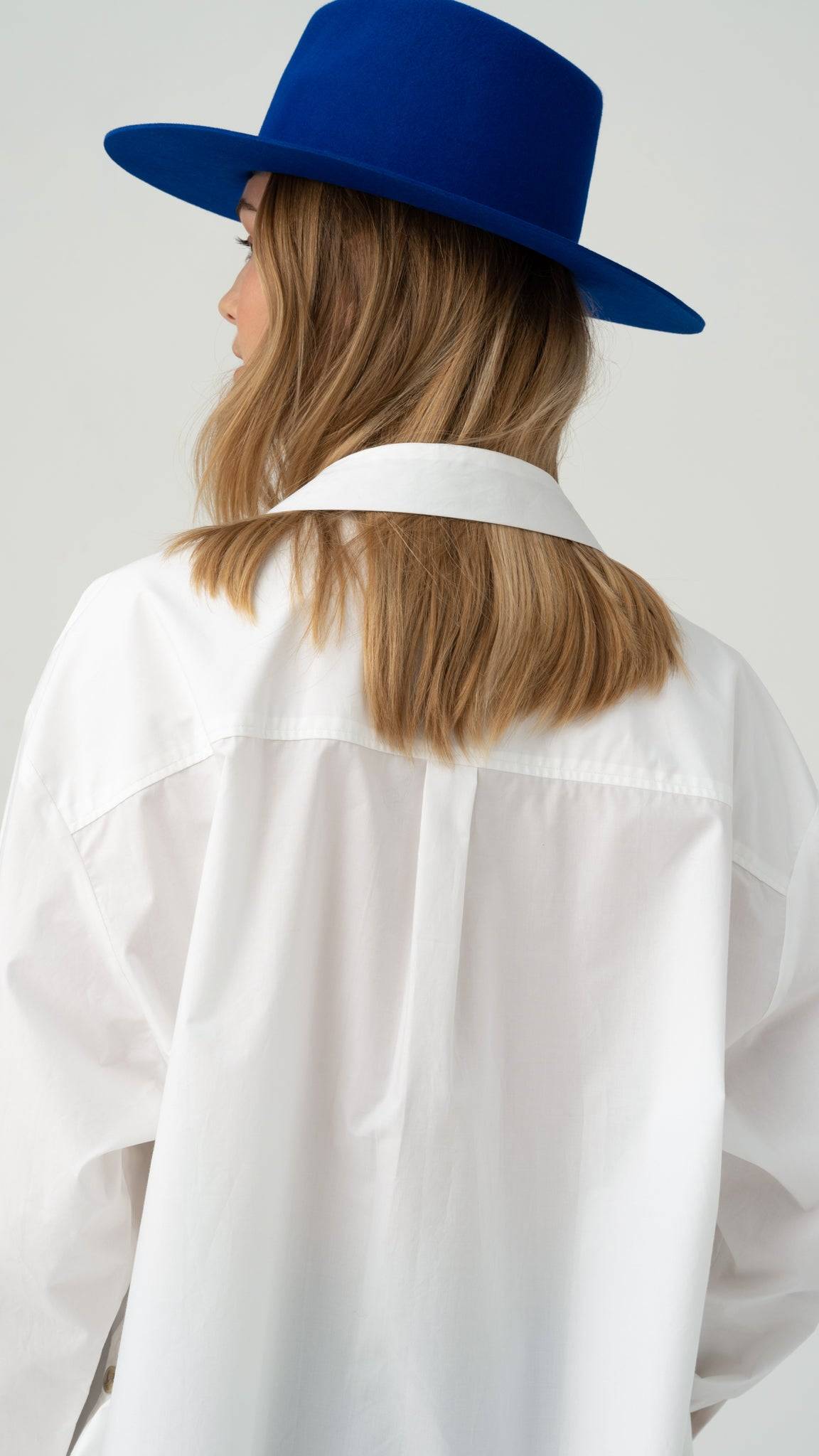 Back view of a royal blue fedora hat, showcasing its structured design. A stylish handcrafted rabbit fur felt hat for a sophisticated look.