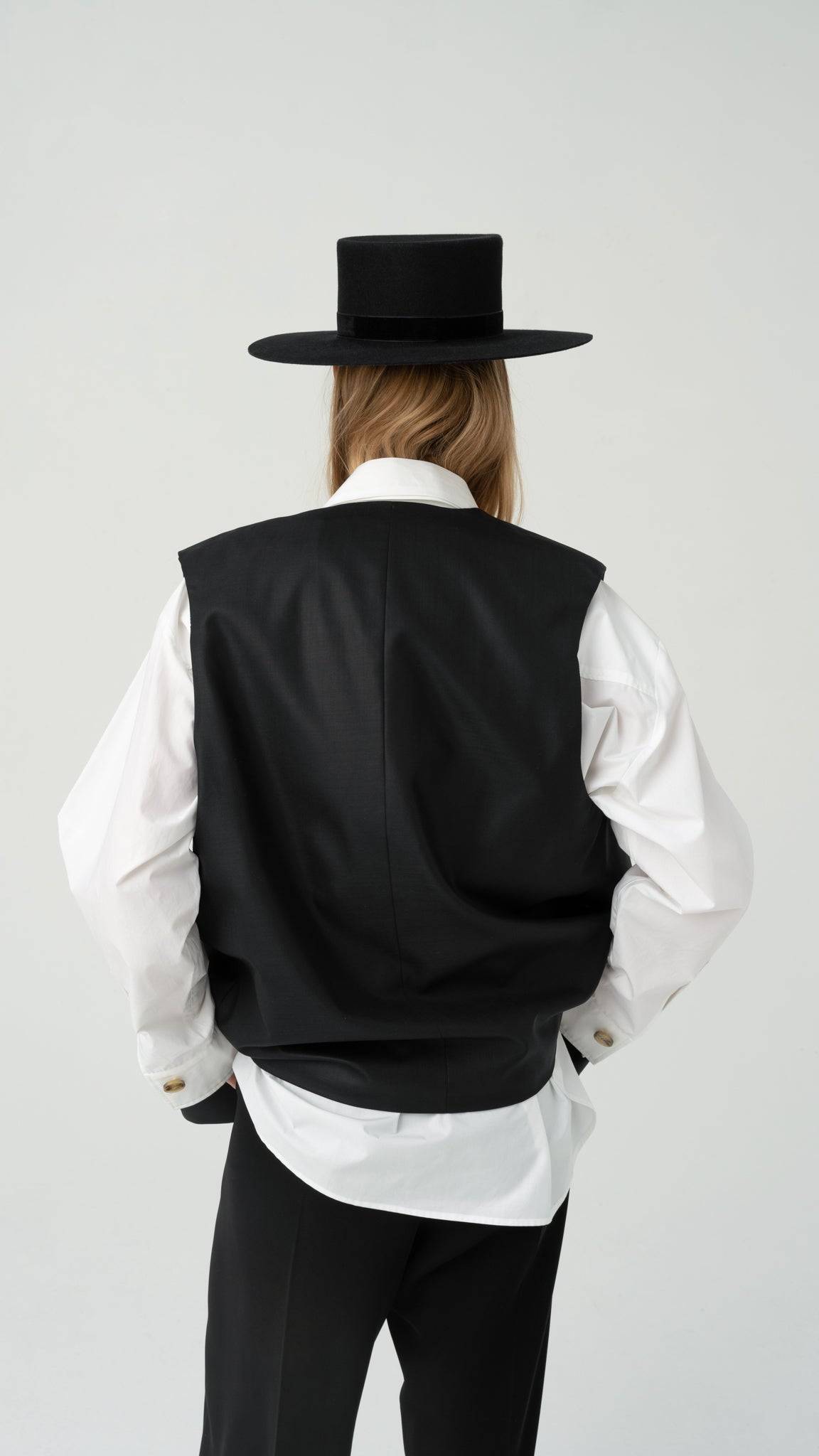 Classic black boater hat with a structured design, featuring a velvet ribbon. A sophisticated and handmade fashion statement for any occasion.