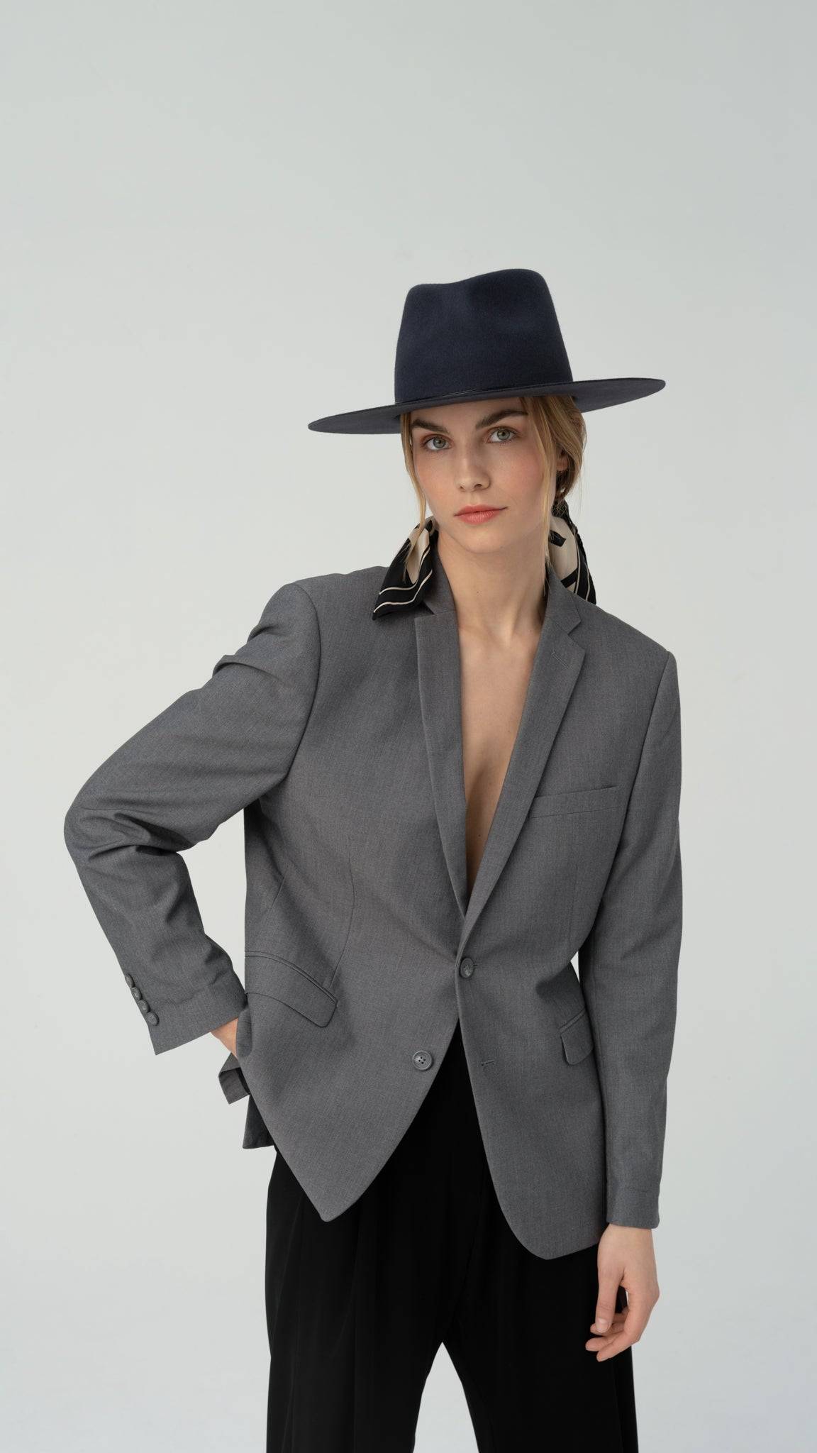 Classic coal grey fedora hat worn with a structured grey blazer. This luxury felt fedora blends modern sophistication with timeless style, ideal for versatile wear.