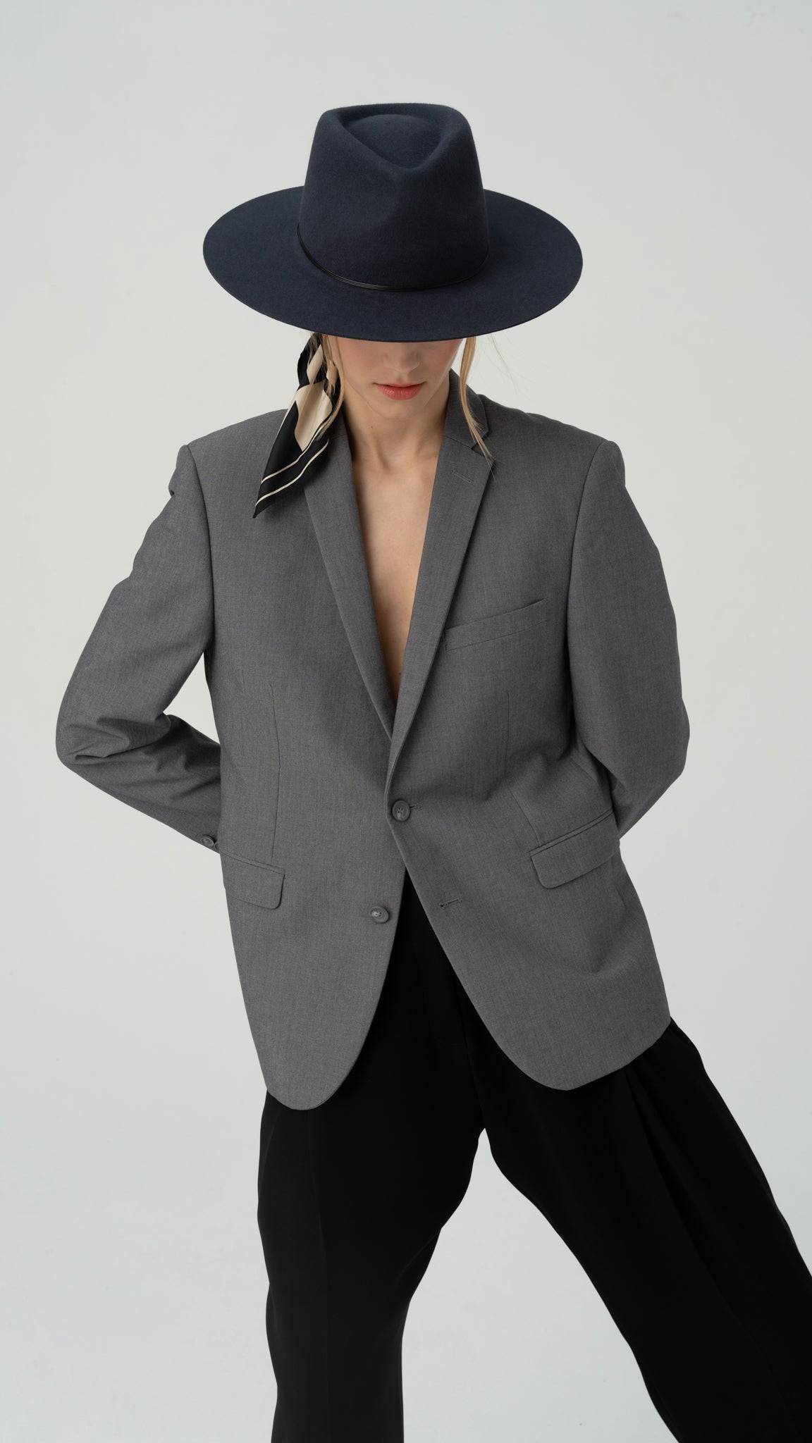 Elegant coal grey fedora hat paired with a tailored grey blazer. A handcrafted designer hat made from premium rabbit fur felt, perfect for formal and fashion-forward occasions.