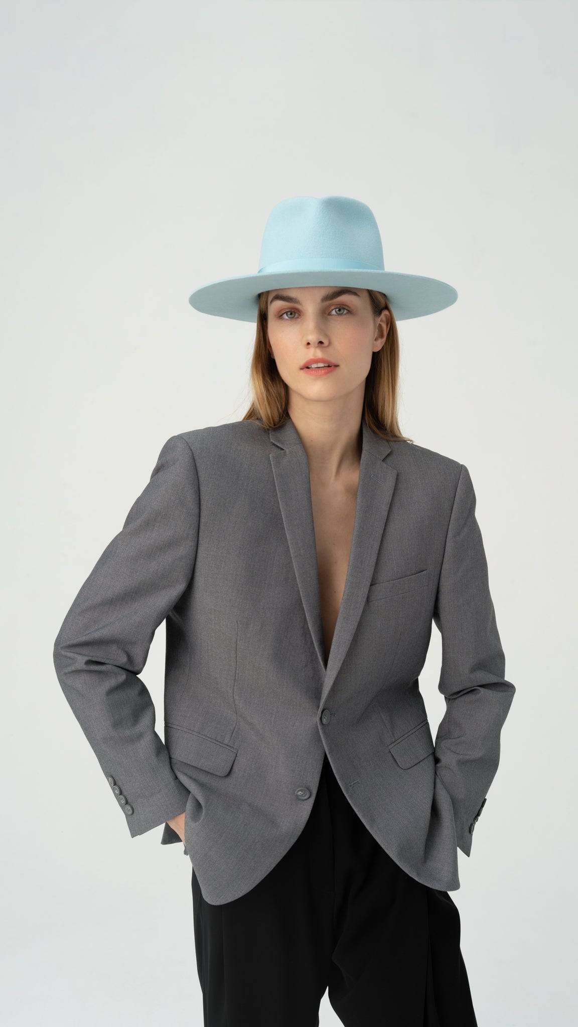 Sky Blue Borisetti Fedora Hat styled with a gray blazer. Handcrafted luxury hat made from premium rabbit fur, perfect for elegant fashion.