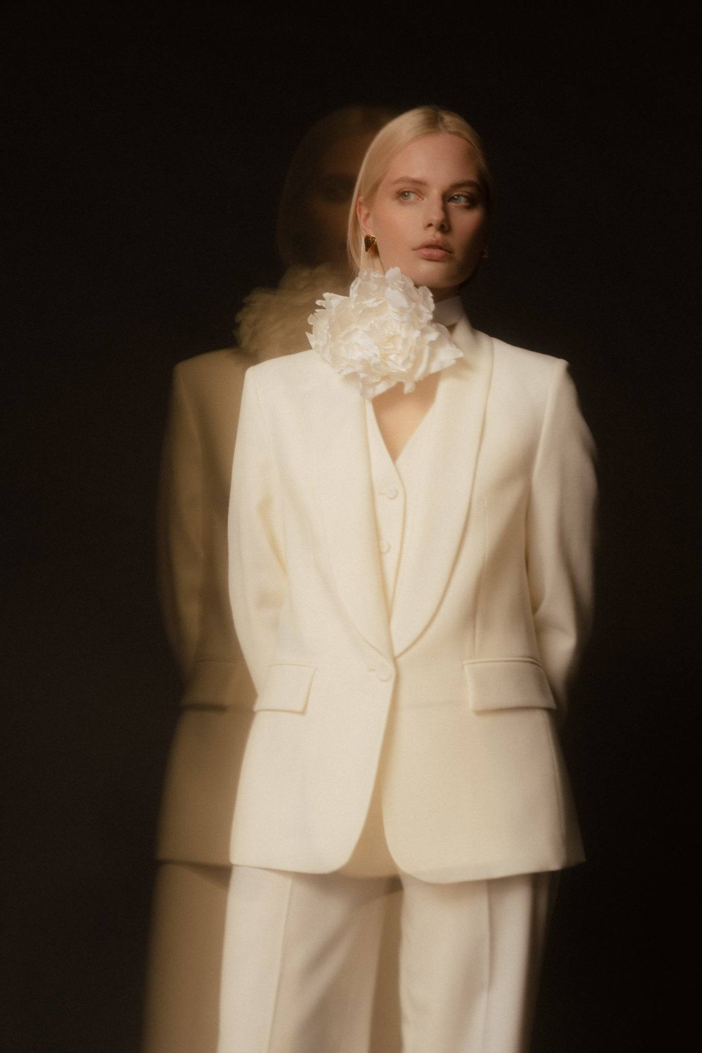Shop Borisetti Silk Peony Brooch & Choker, a delicate handcrafted floral accessory styled with a white suit for timeless fashion.