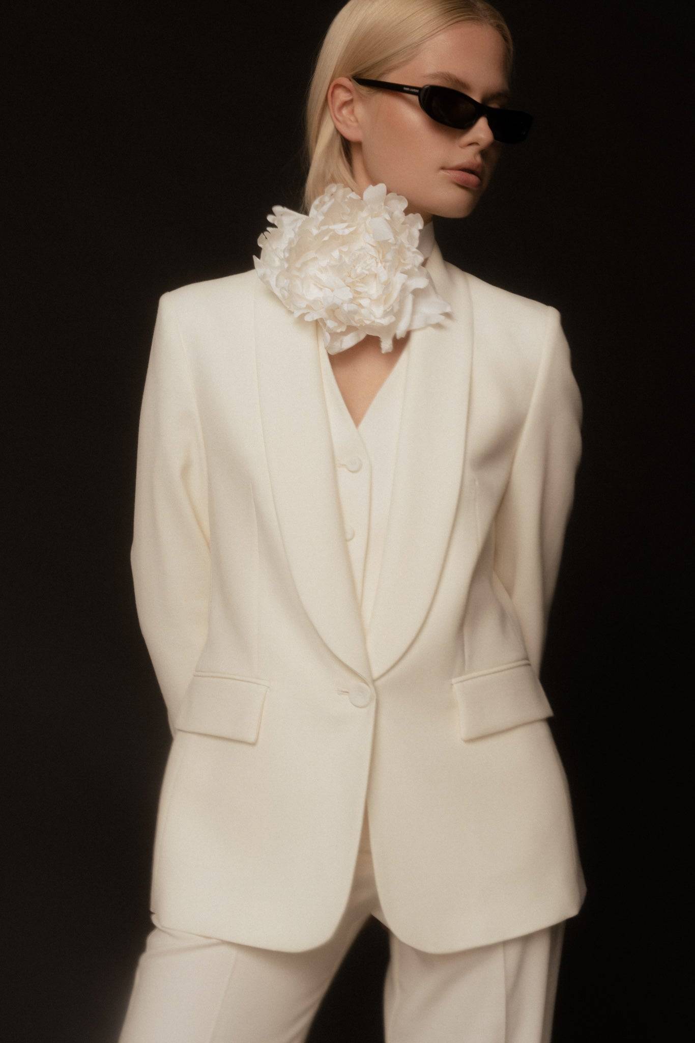 Handcrafted Borisetti Silk Peony Brooch & Choker, a white silk floral accessory elegantly paired with a tailored suit. Buy now online.