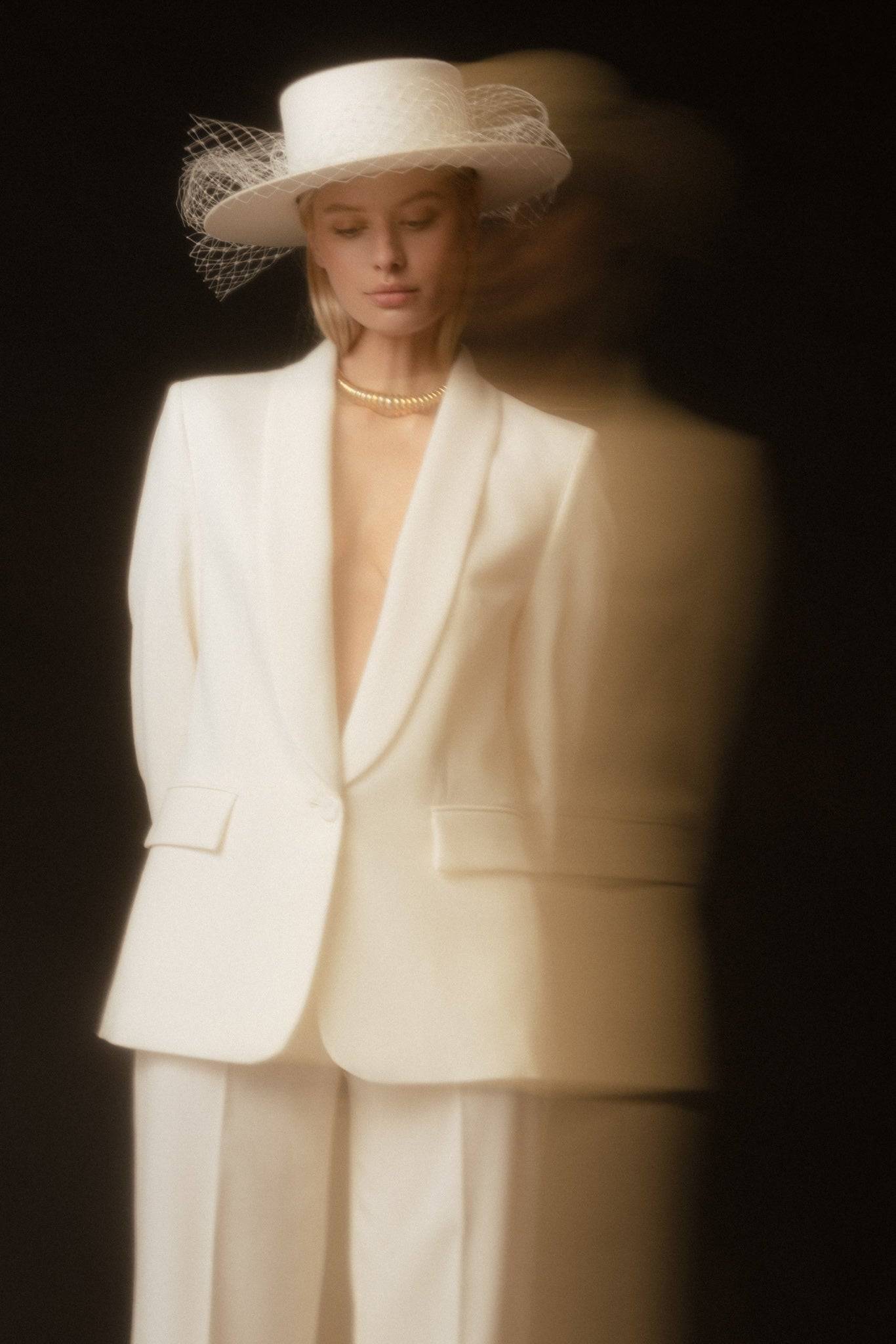 Elegant bridal boater hat with removable veil, featuring a classic design in ivory. Perfect for weddings and special occasions.