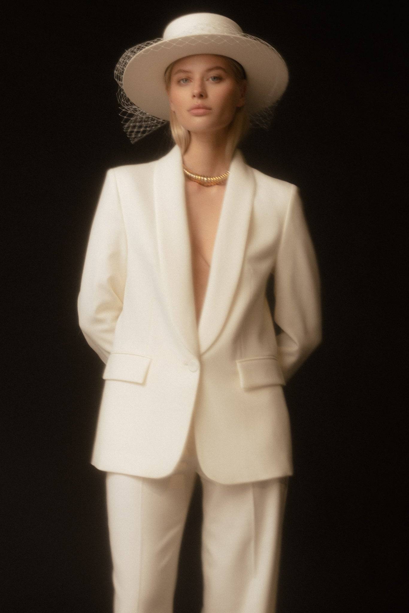 Sophisticated ivory boater hat with a delicate removable veil, ideal for modern bridal looks and timeless wedding accessories.