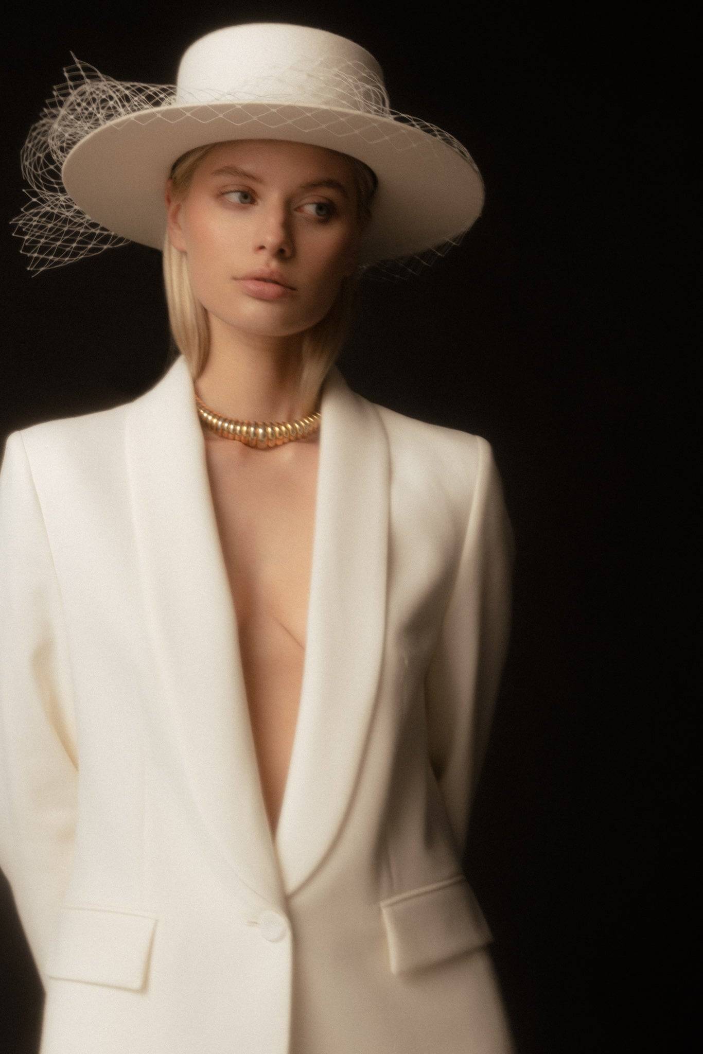 Bridal boater hat with a removable veil, handcrafted for elegance. A versatile wedding day accessory for a refined and stylish look.