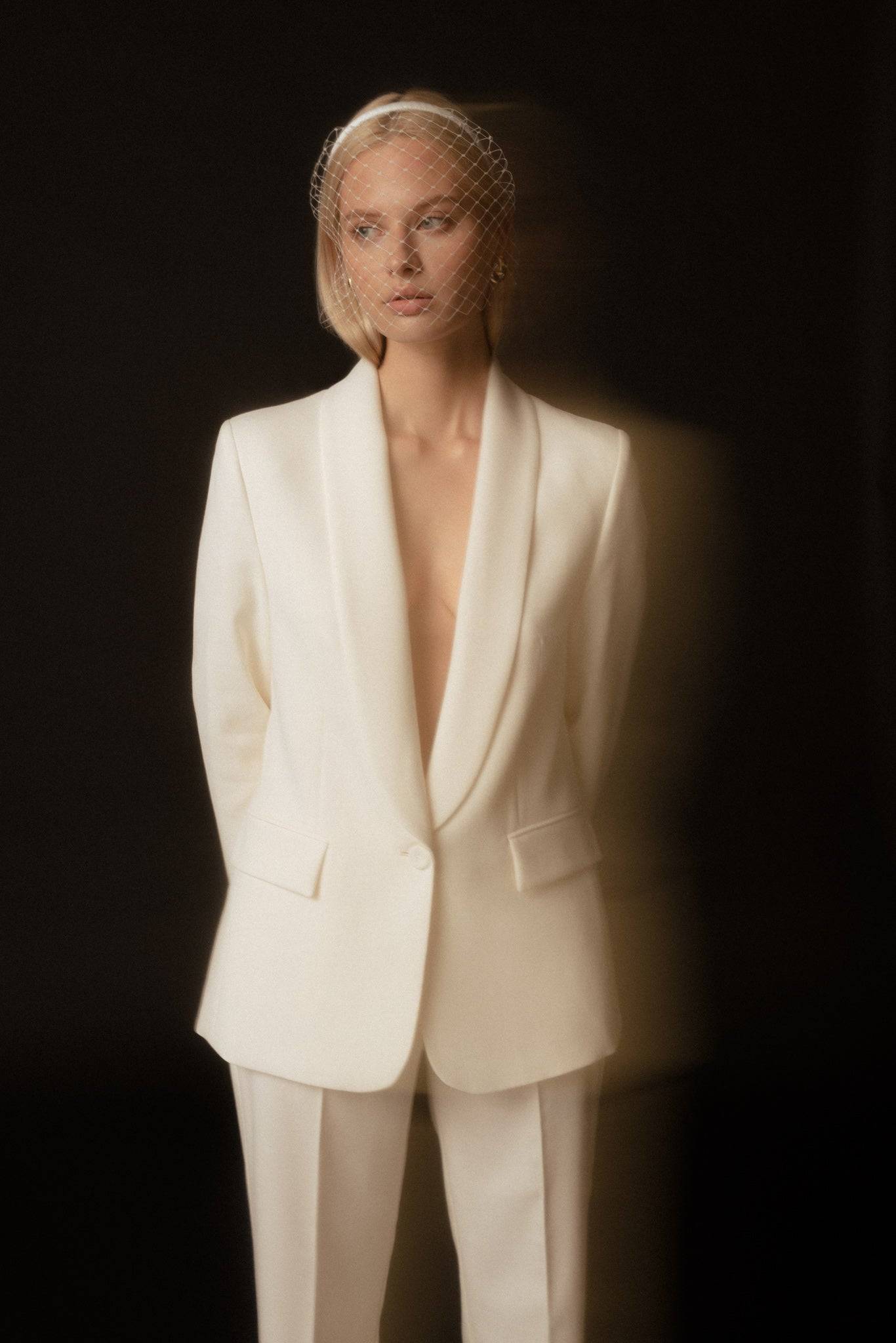 Elegant ivory veil-detail satin silk headband worn with a white blazer. A timeless handcrafted bridal accessory for sophisticated styling.