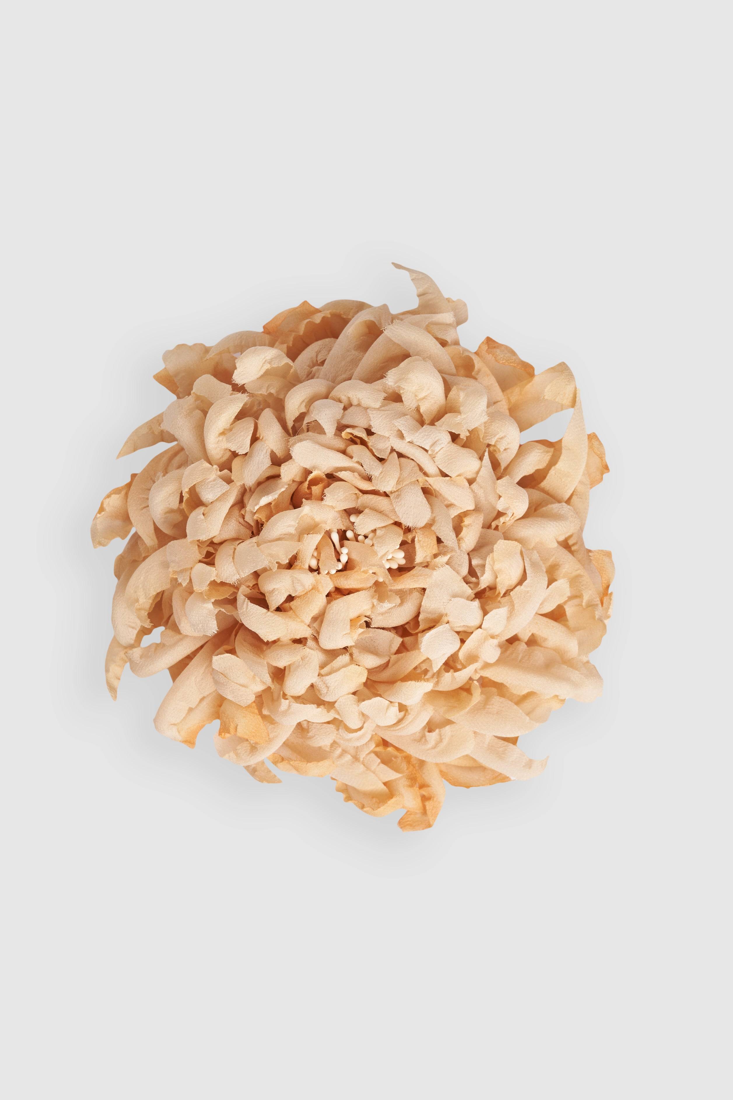 Silk Chrysanthemum brooch handcrafted in cream tones, designed for elegance and versatility. A delicate millinery accessory for refined styling.