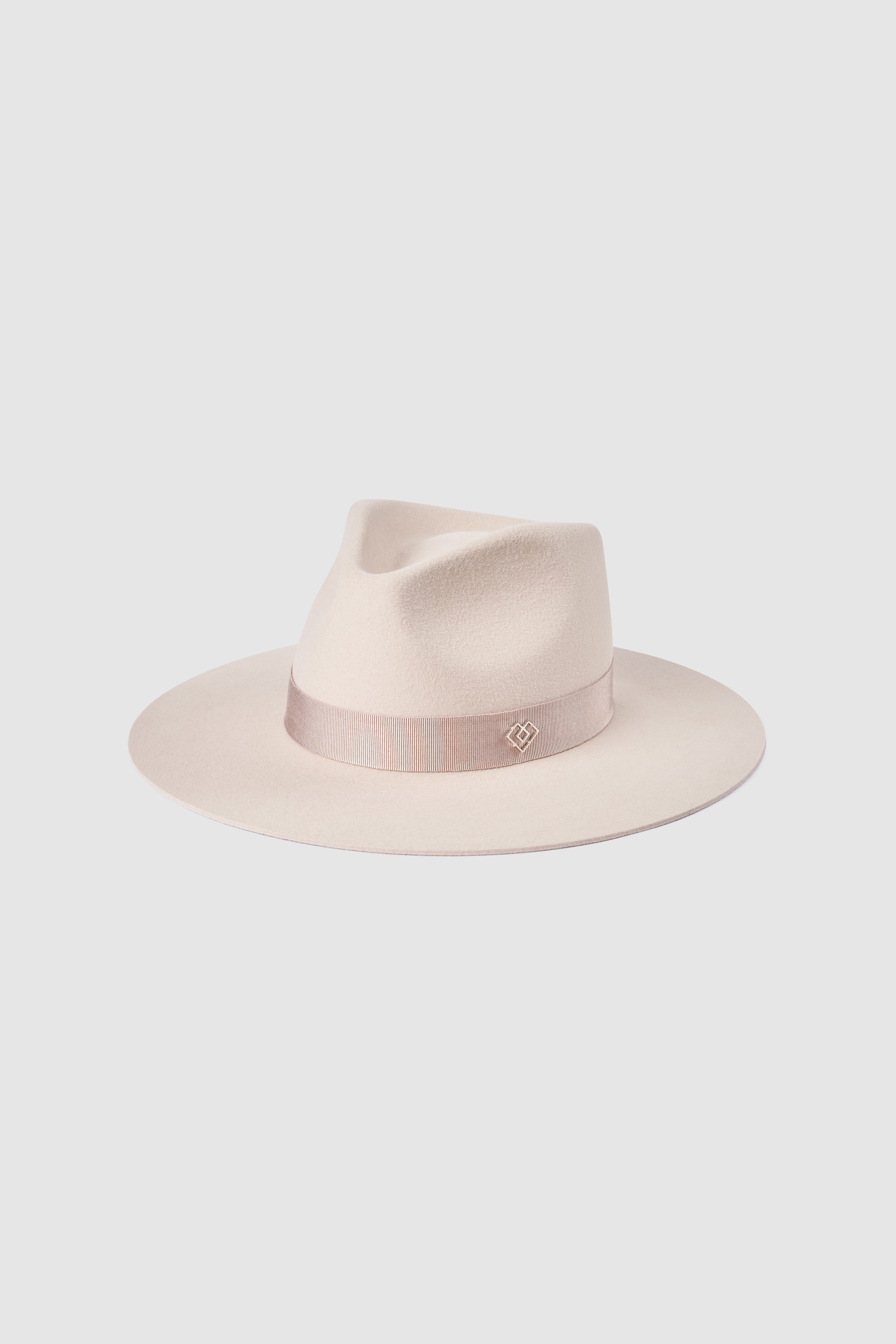 Handcrafted light rose fedora hat with a wide brim, made from 100% rabbit fur felt. Features a signature monogram embellishment on a pink ribbon band.
