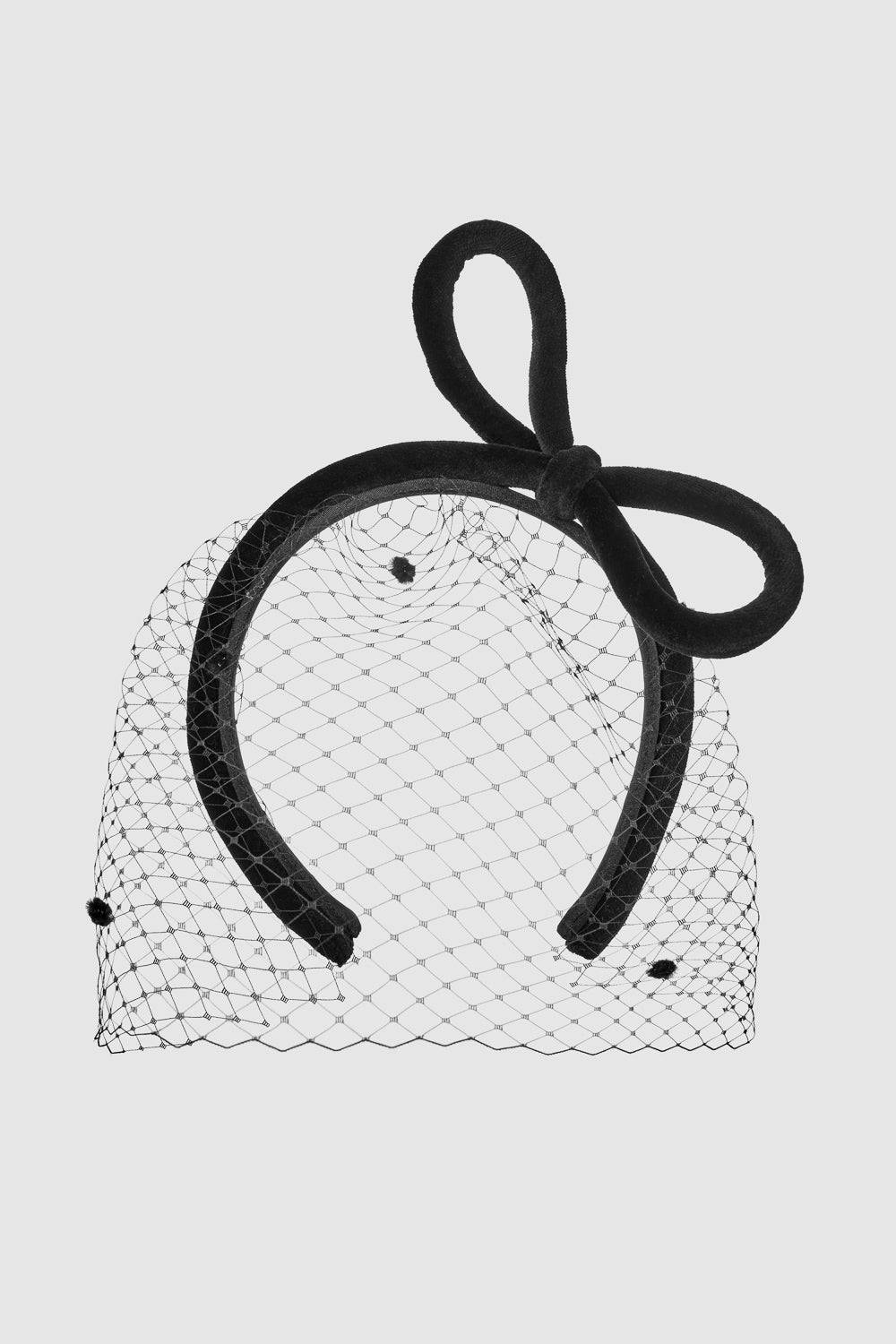Black bow embellished headband with delicate veil, a handcrafted millinery hair accessory for weddings, parties, and red carpet events.