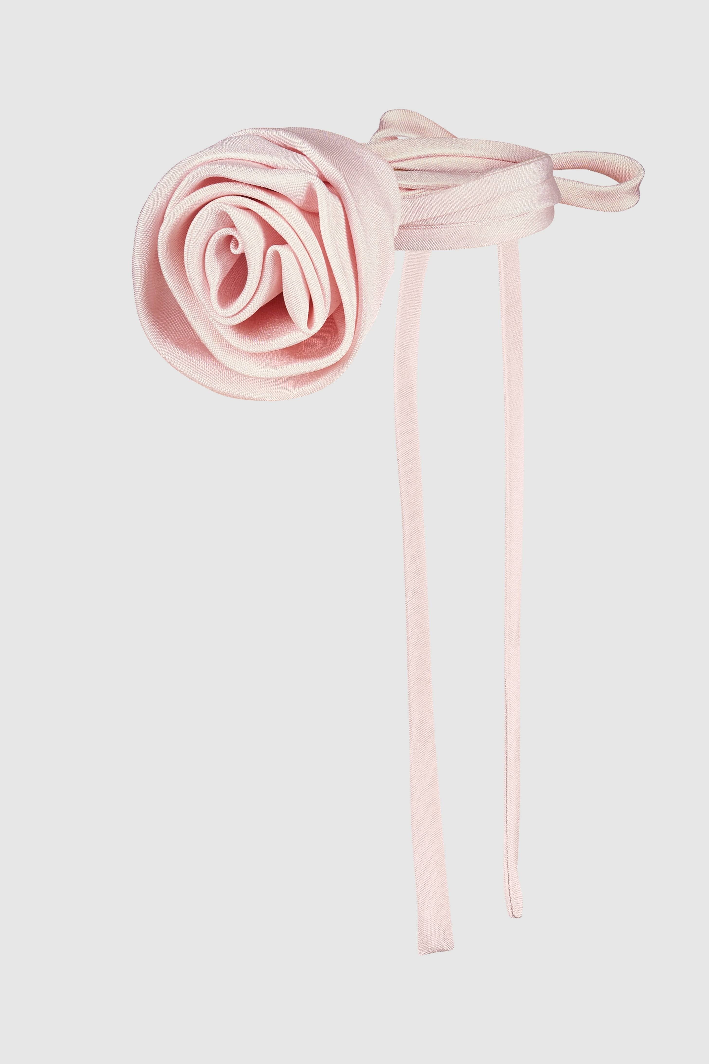 Close-up of a designer silk rose choker in soft pink. A handmade millinery jewelry piece, ideal for elegant and statement fashion.