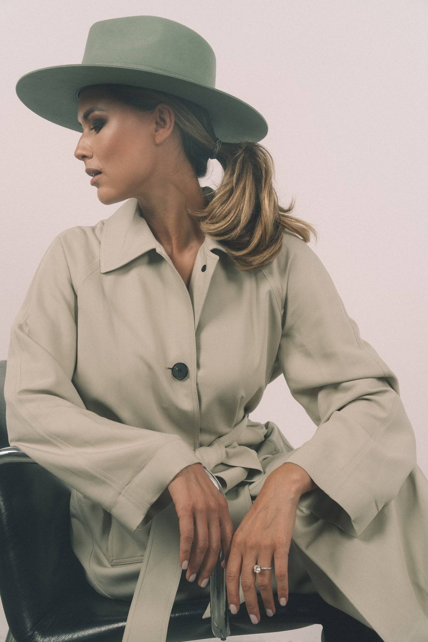 Side profile of a woman in Borisetti green fedora hat. A high-fashion statement fedora made from premium rabbit fur felt with monogram.