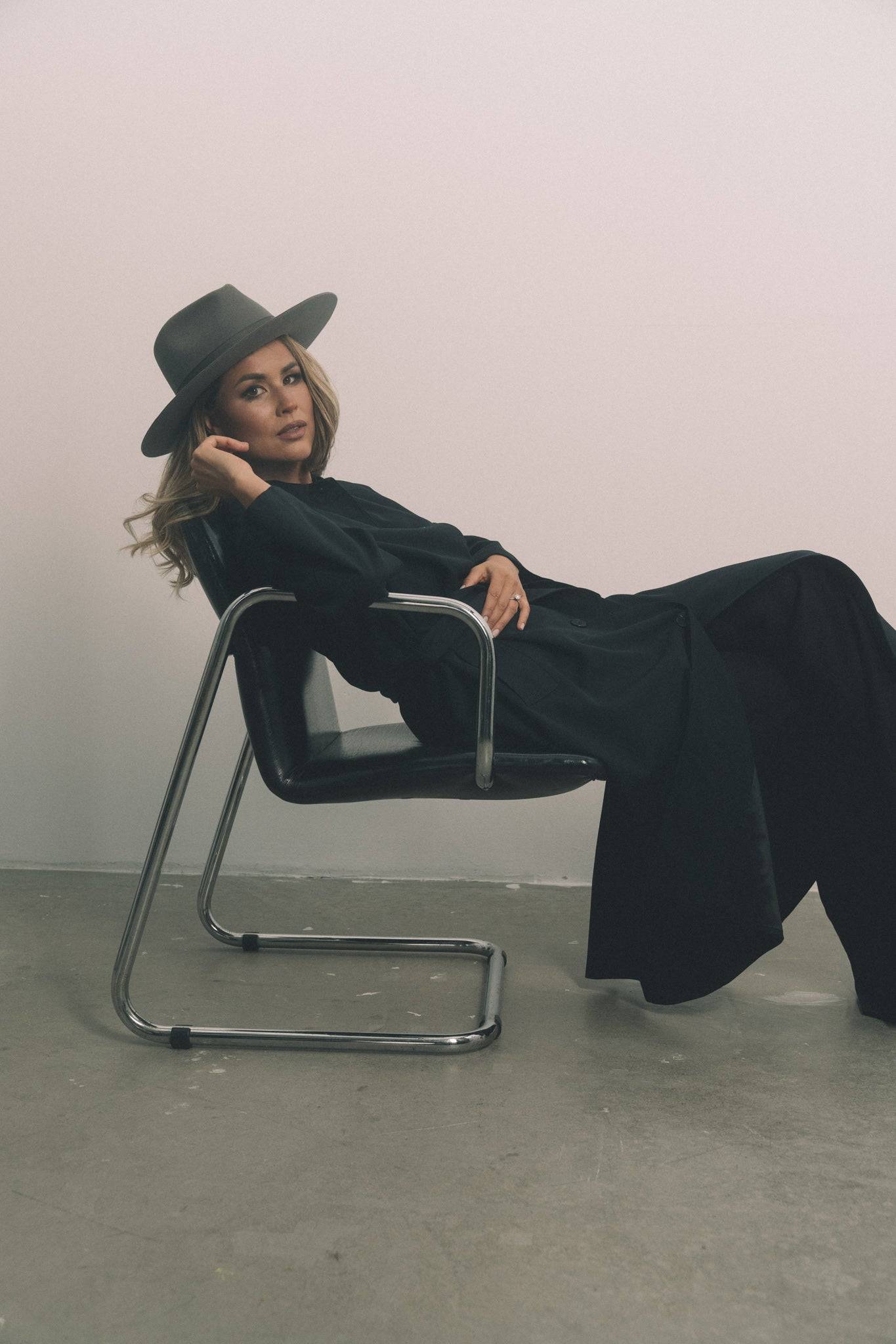 Handcrafted grey fedora hat styled with a black coat. A statement piece made from premium rabbit fur felt for ultimate elegance. Order now.