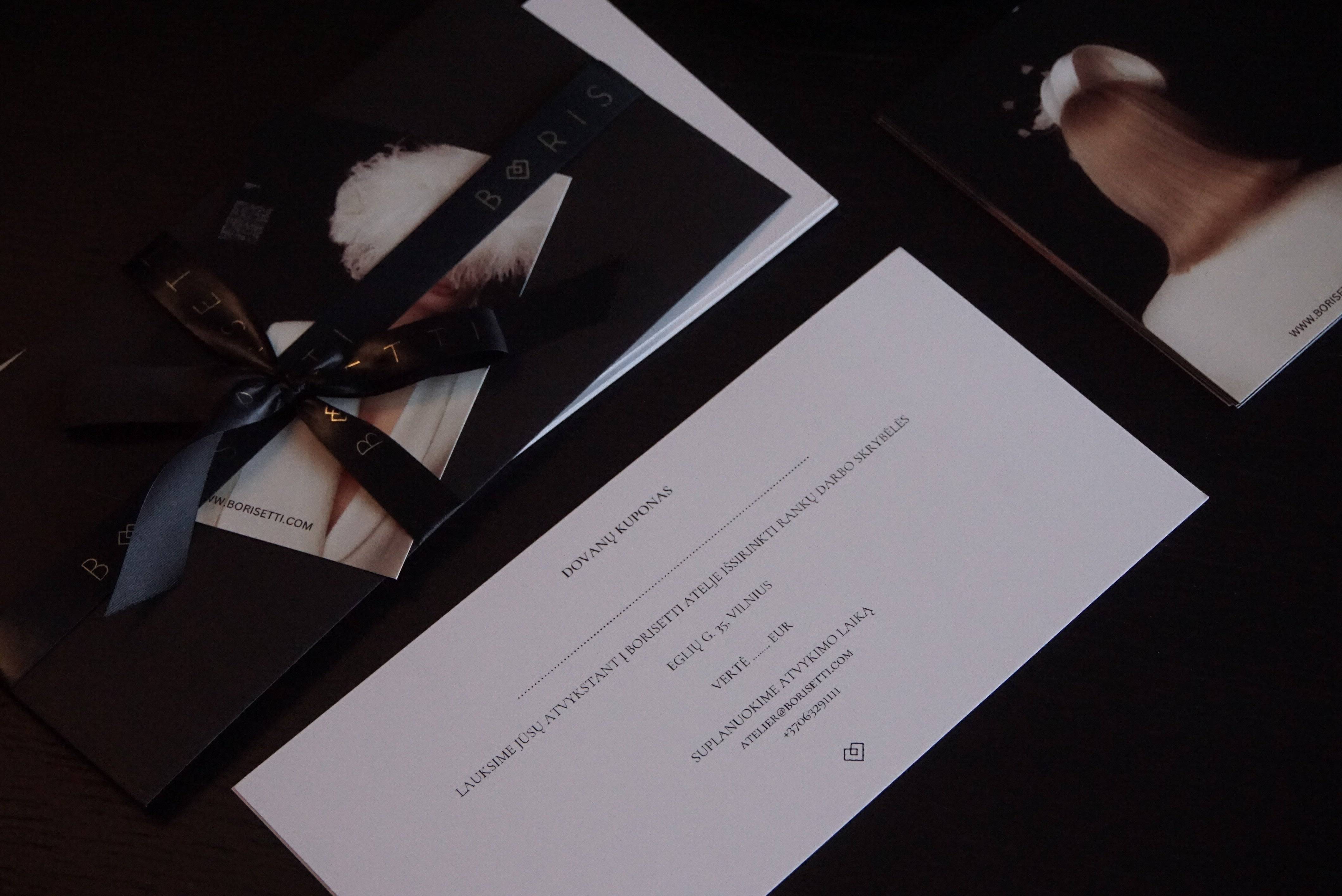 Borisetti Gift Card elegantly wrapped with a black ribbon, accompanied by a stylish envelope and artistic promotional materials. Perfect for gifting.