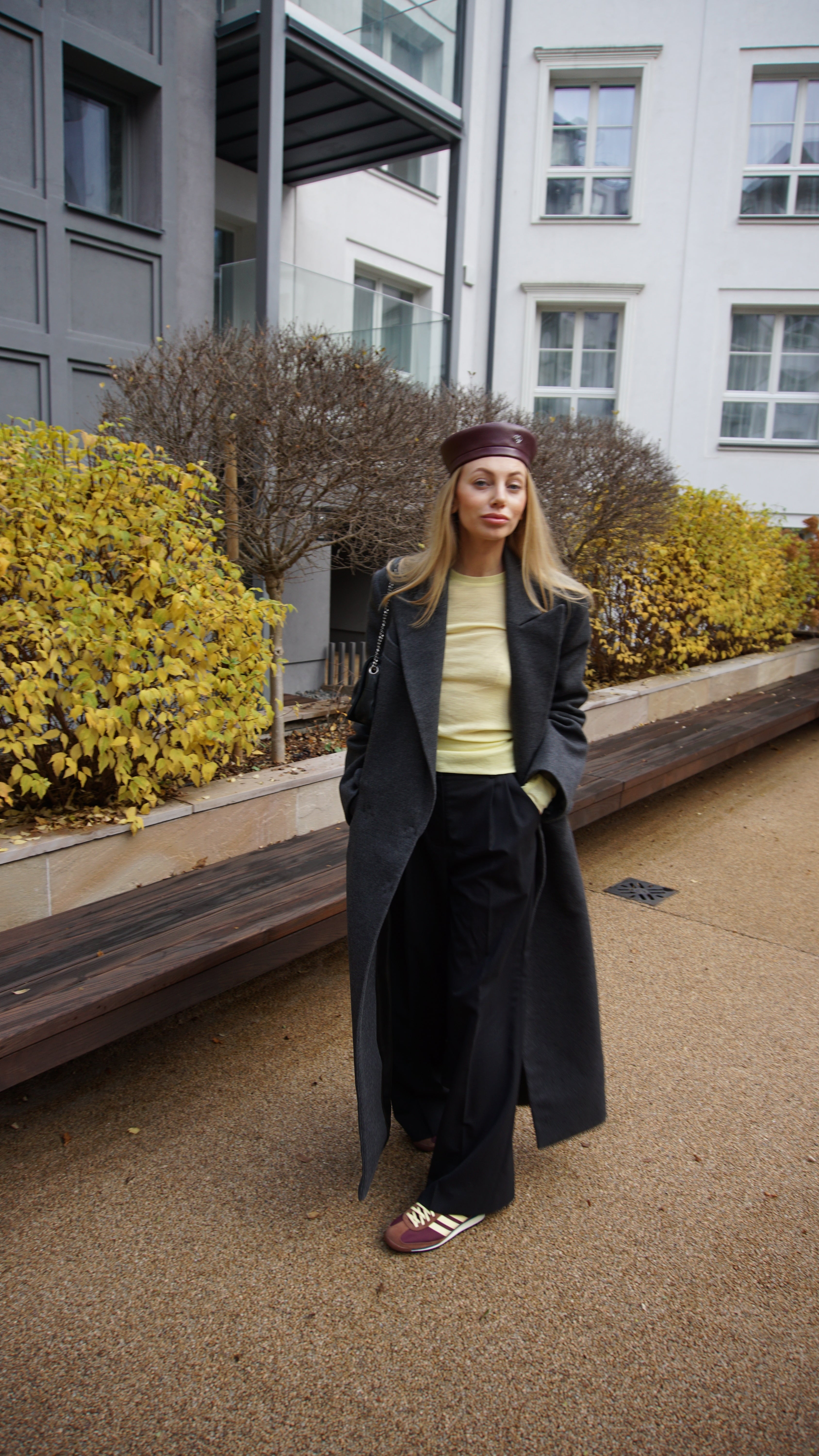 Burgundy leather beret paired with a dark gray coat and casual chic outfit. A must-have fashion beret for a stylish and polished look.