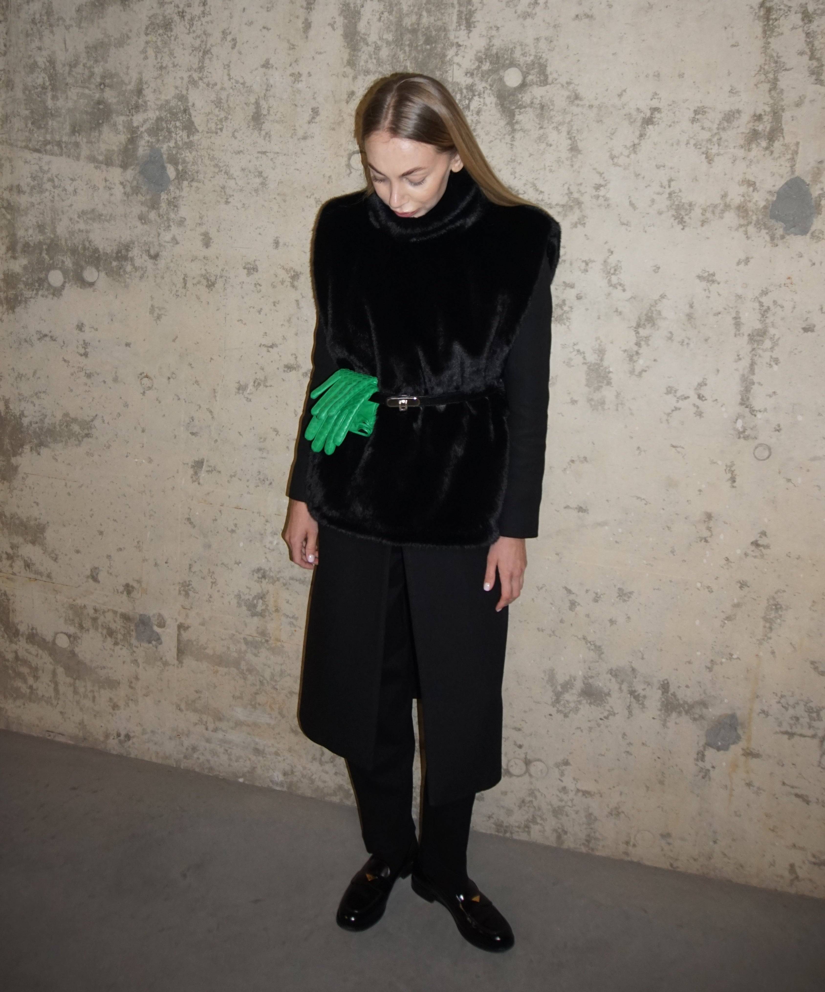 Chic black faux fur turtleneck styled with a belted coat and tailored trousers. A refined winter wardrobe staple for a polished and cozy outfit.
