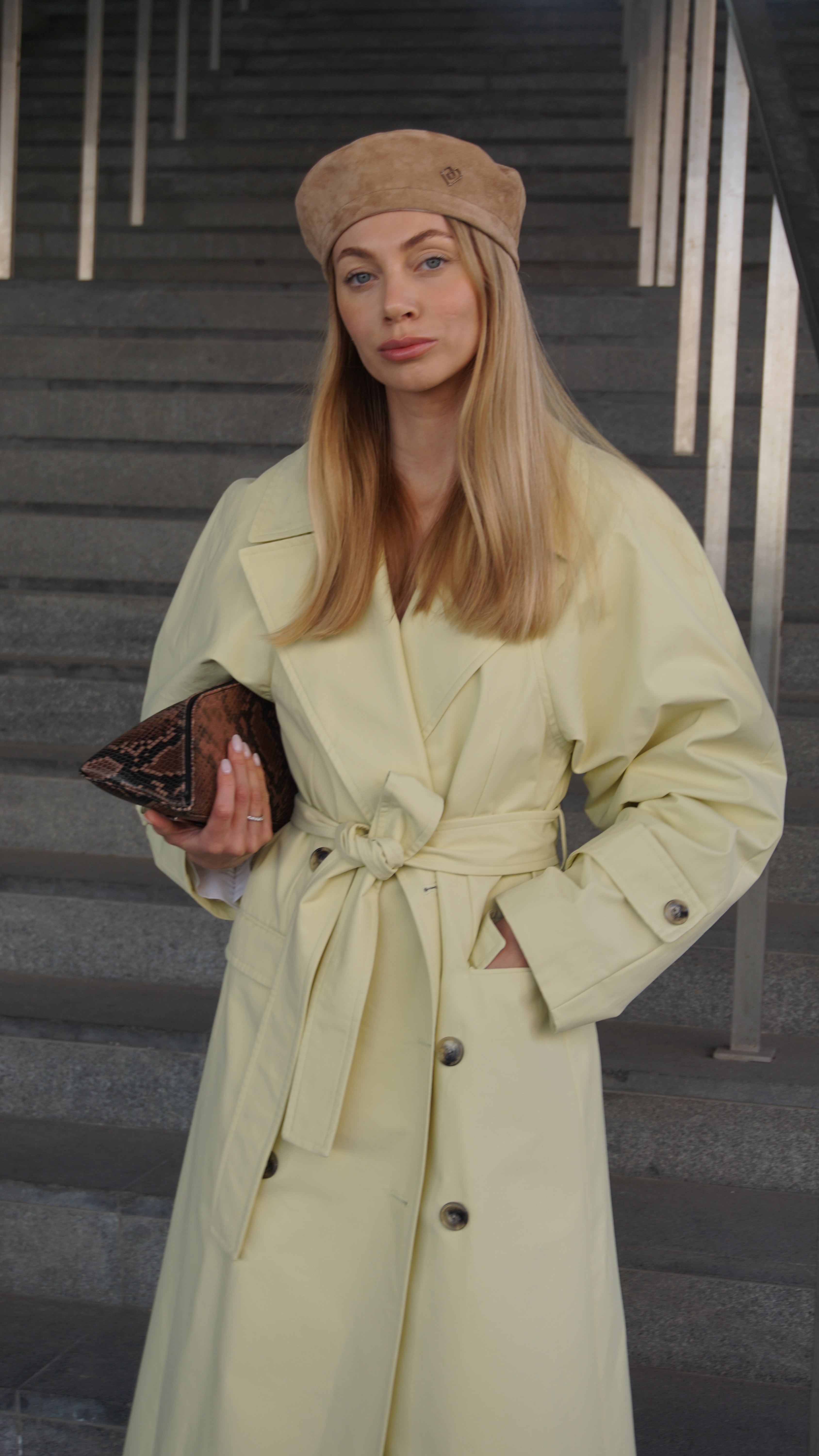 Light brown suede leather beret styled with a chic beige trench coat. Elevate your fashion with this Parisian-inspired accessory. Shop now for up to 10% off.