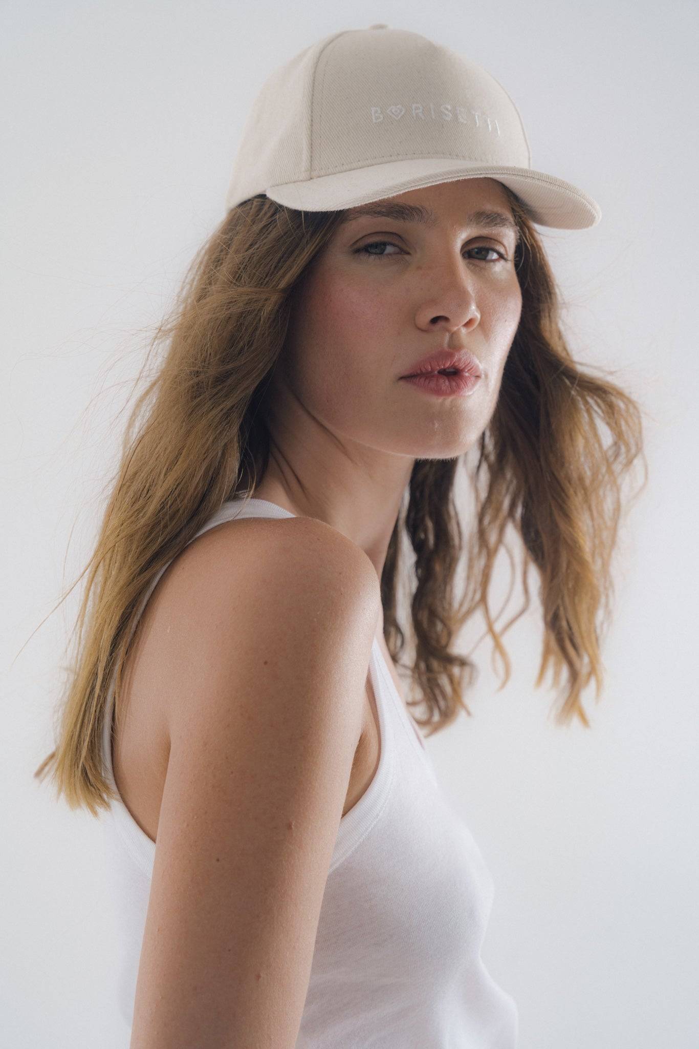 Close-up of Borisetti Denim Baseball Cap in light beige, showcasing its embroidered logo and premium craftsmanship for a timeless fashion piece.