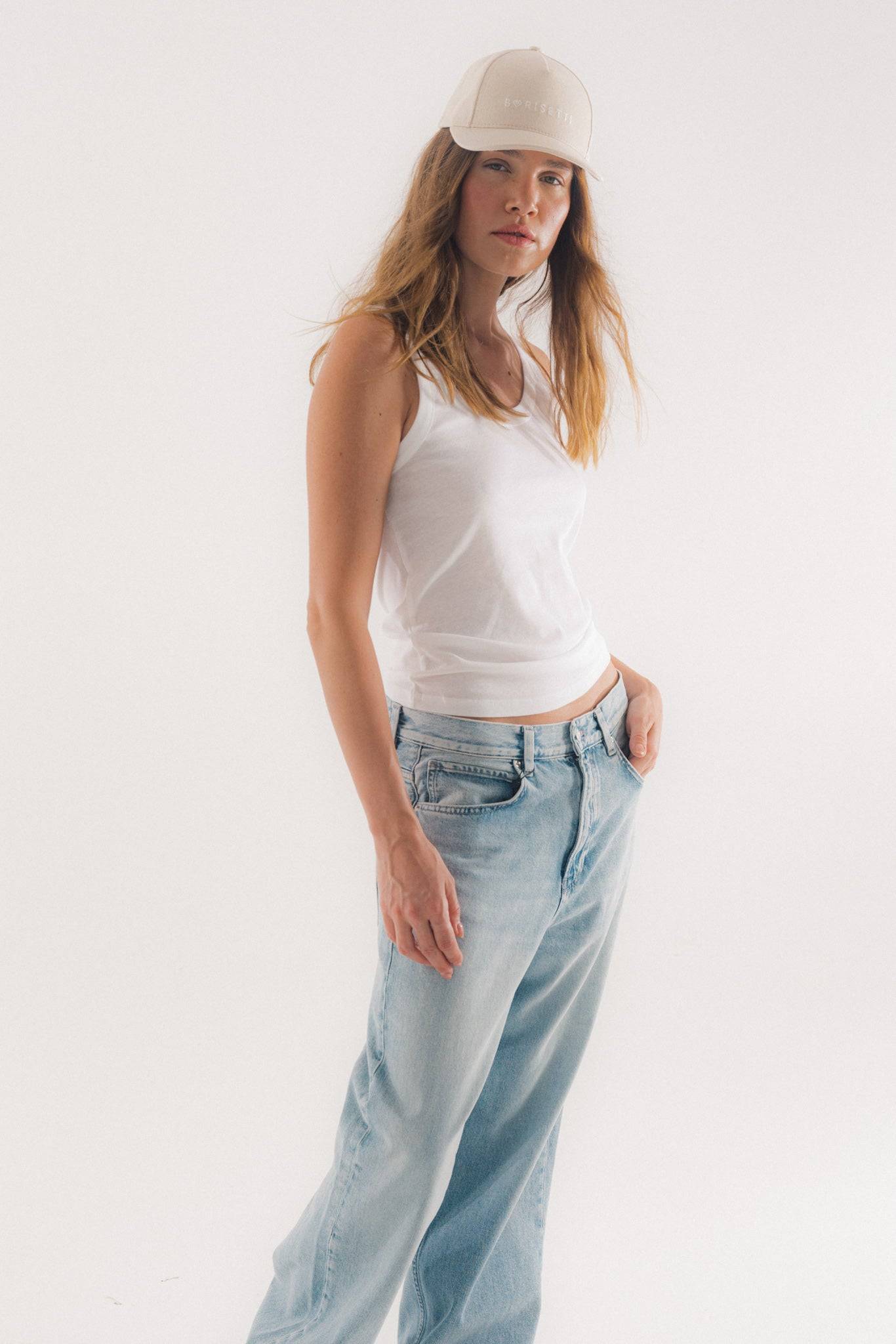 Borisetti Denim Baseball Cap in light beige, styled with a white tank top and relaxed-fit jeans for a trendy, effortless outfit.