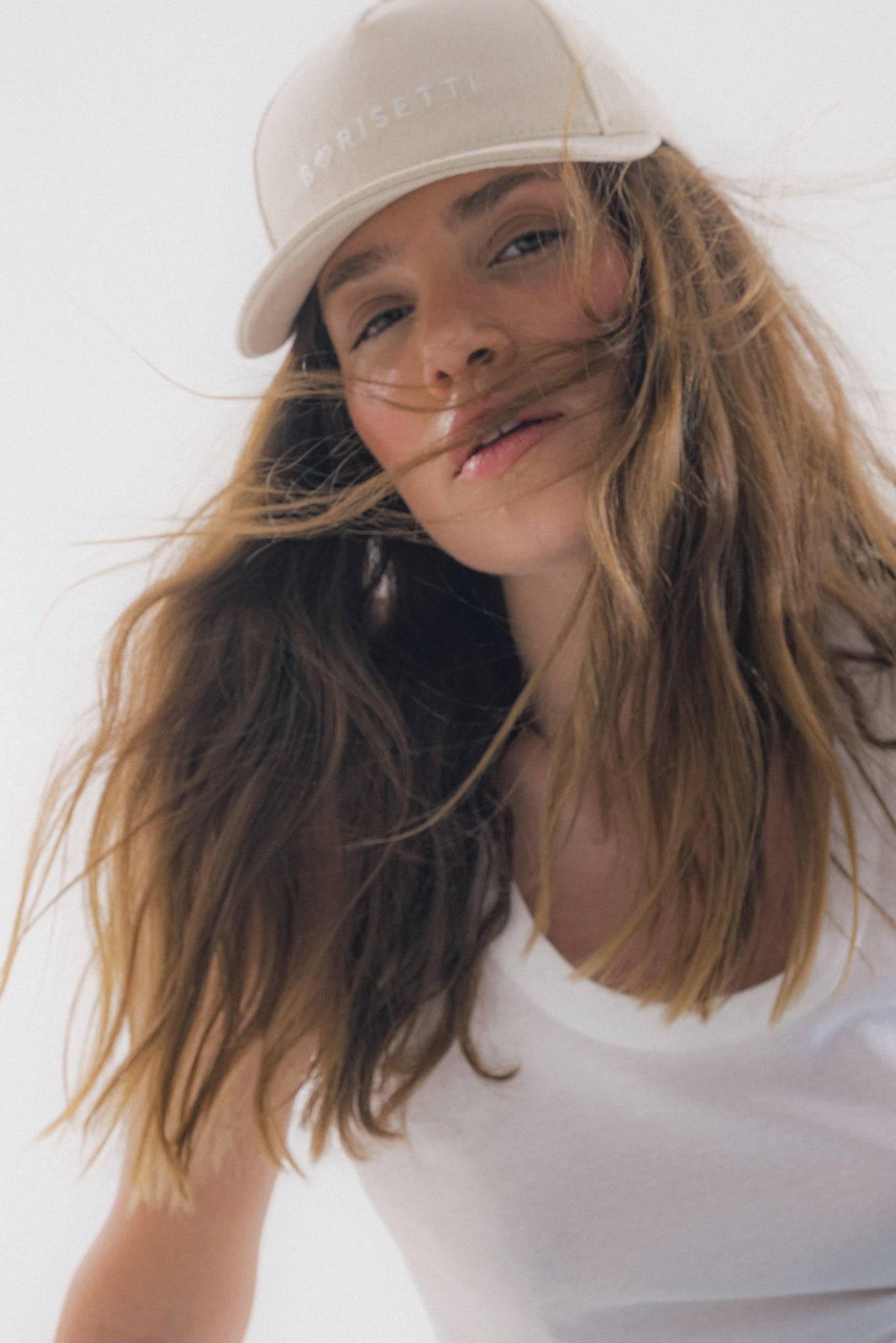Wind-swept look featuring Borisetti Denim Baseball Cap in light beige, a trendy and handcrafted accessory for modern, effortless fashion.
