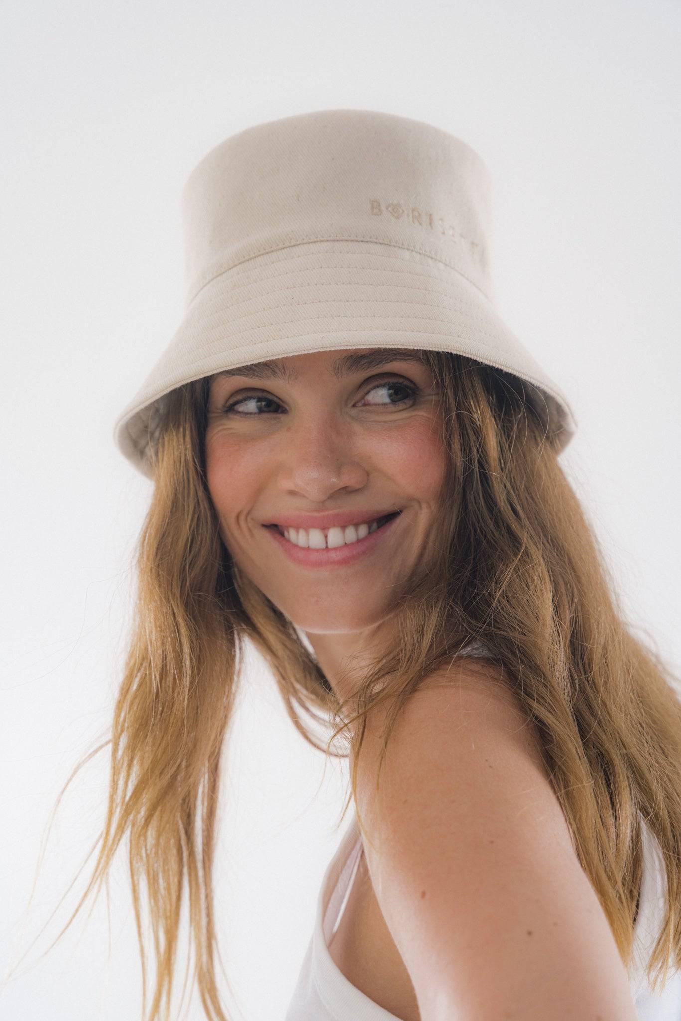 Beige denim bucket hat with a relaxed fit, ideal for street-style fashion. A must-have accessory for minimalist and travel-ready looks.