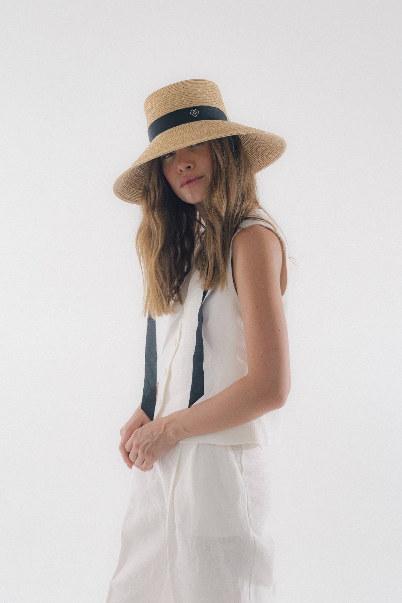 Chic neck tie wide brimmed straw hat with black ribbon, perfect for summer elegance and sun protection. Handcrafted Italian design for timeless style.