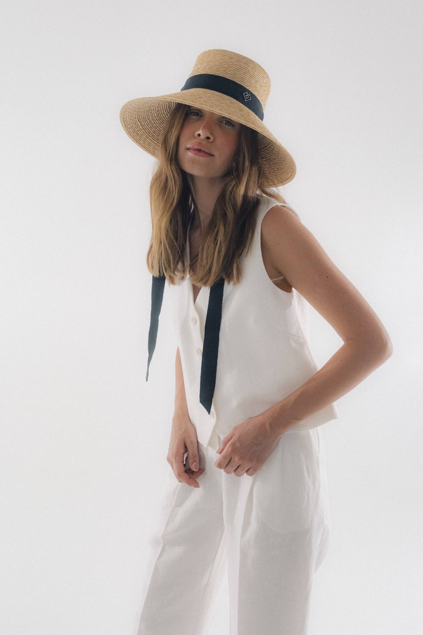 Chic neck tie wide brimmed straw hat with a black ribbon, perfect for summer elegance. Handcrafted Italian design for sun protection and timeless style.