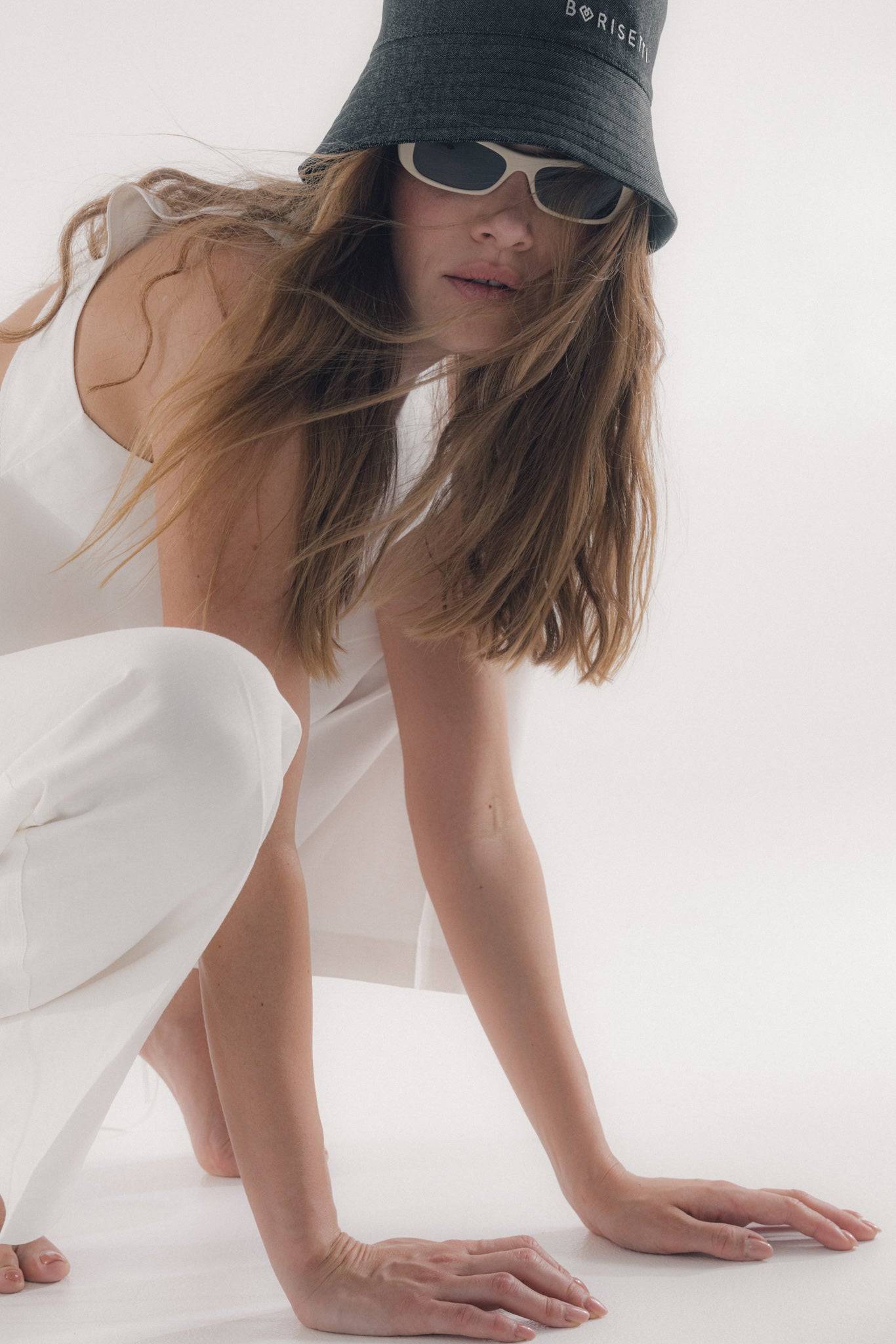 Casual black bucket hat with Borisetti embroidery, paired with a white outfit. Made from 100% cotton for a comfortable and stylish look.