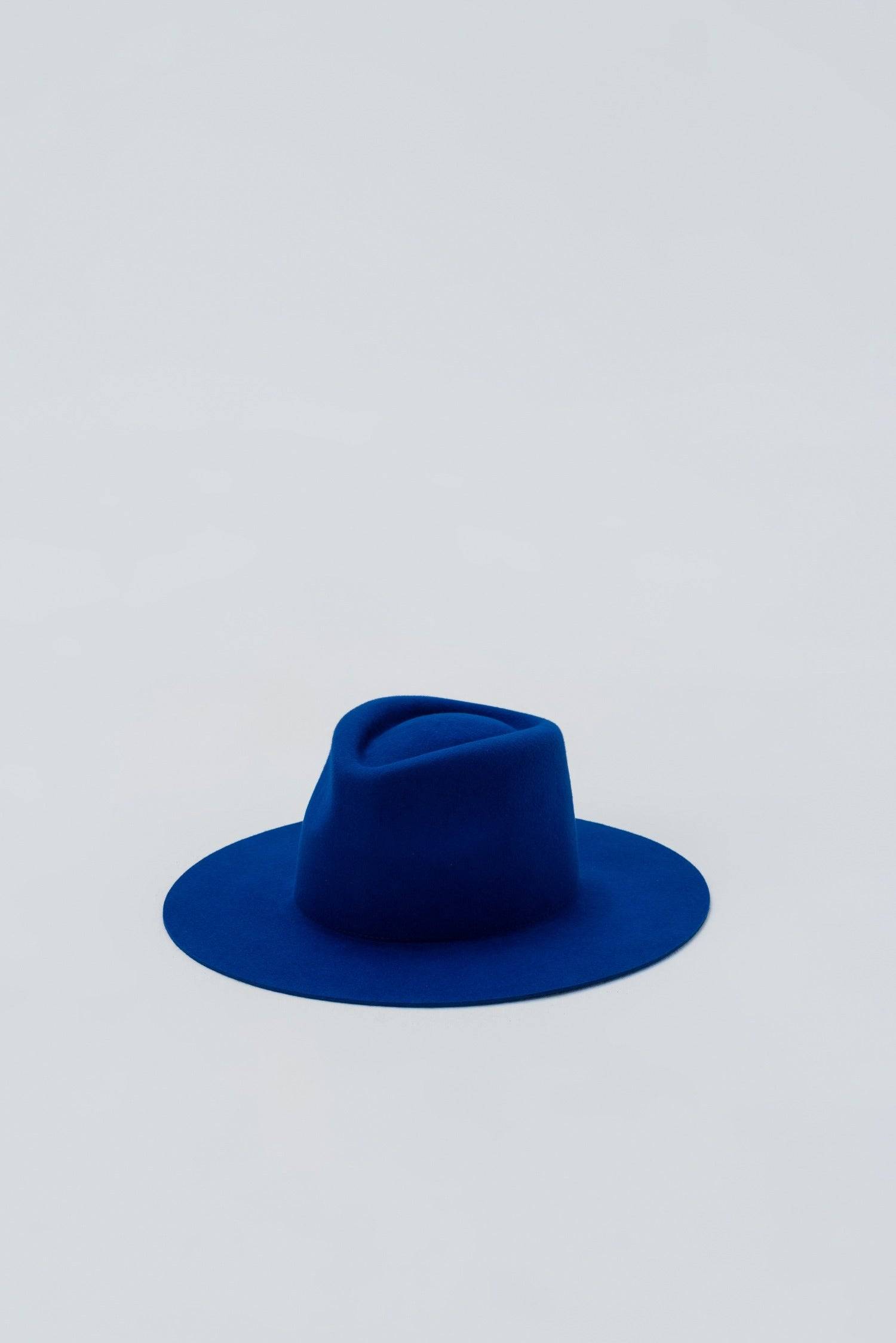 Royal blue fedora hat displayed against a minimal backdrop. A handcrafted rabbit fur felt accessory for a refined and stylish wardrobe.