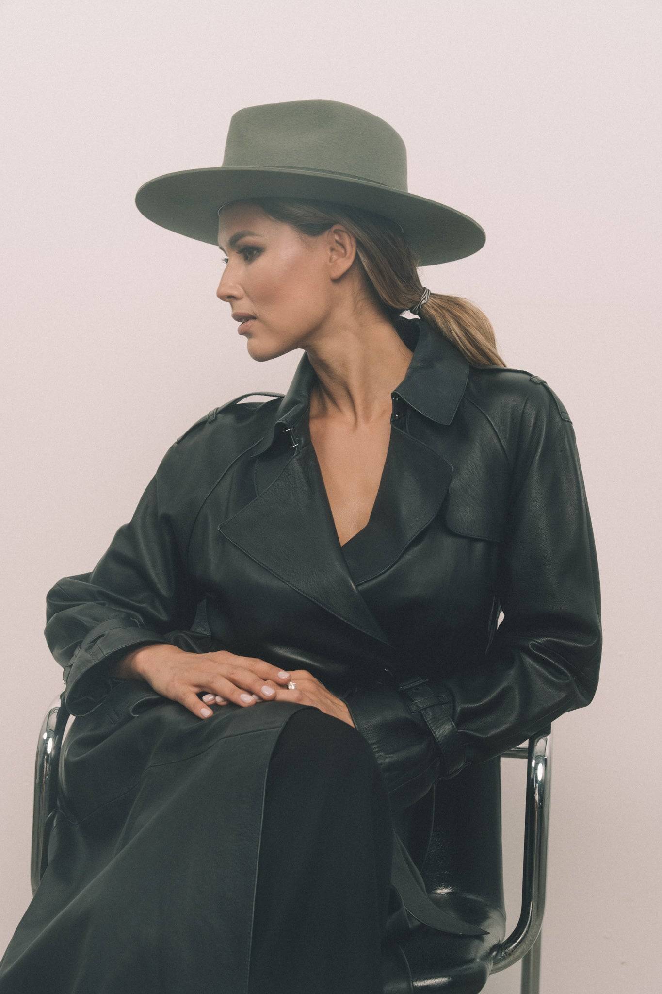 Borisetti military fedora hat in dark green, styled with a black leather trench coat. Handcrafted with rabbit fur felt and petersham ribbon.