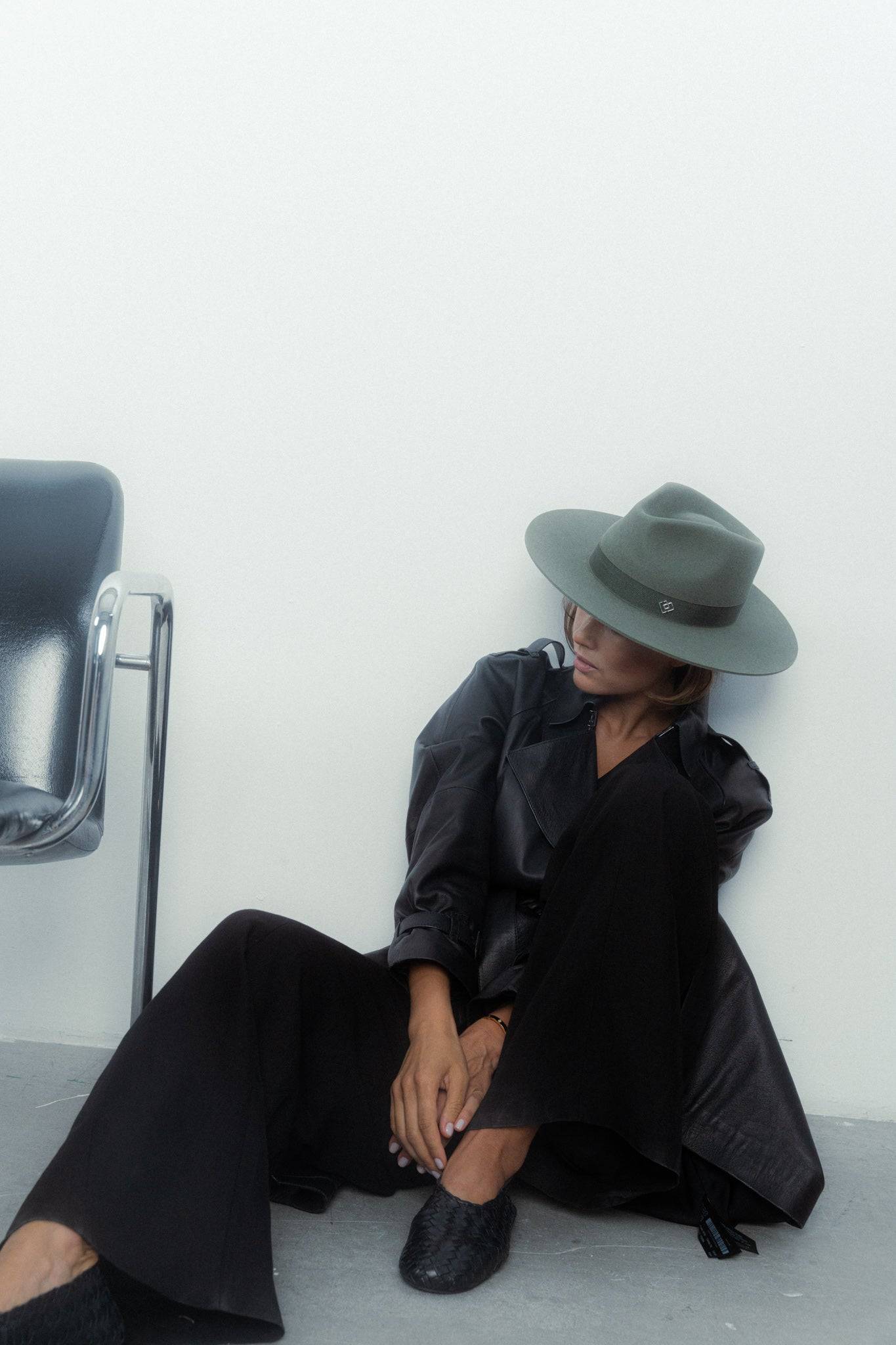 Borisetti military fedora hat in khaki, styled with black wide-leg pants and a leather coat. A sophisticated and versatile fashion piece.