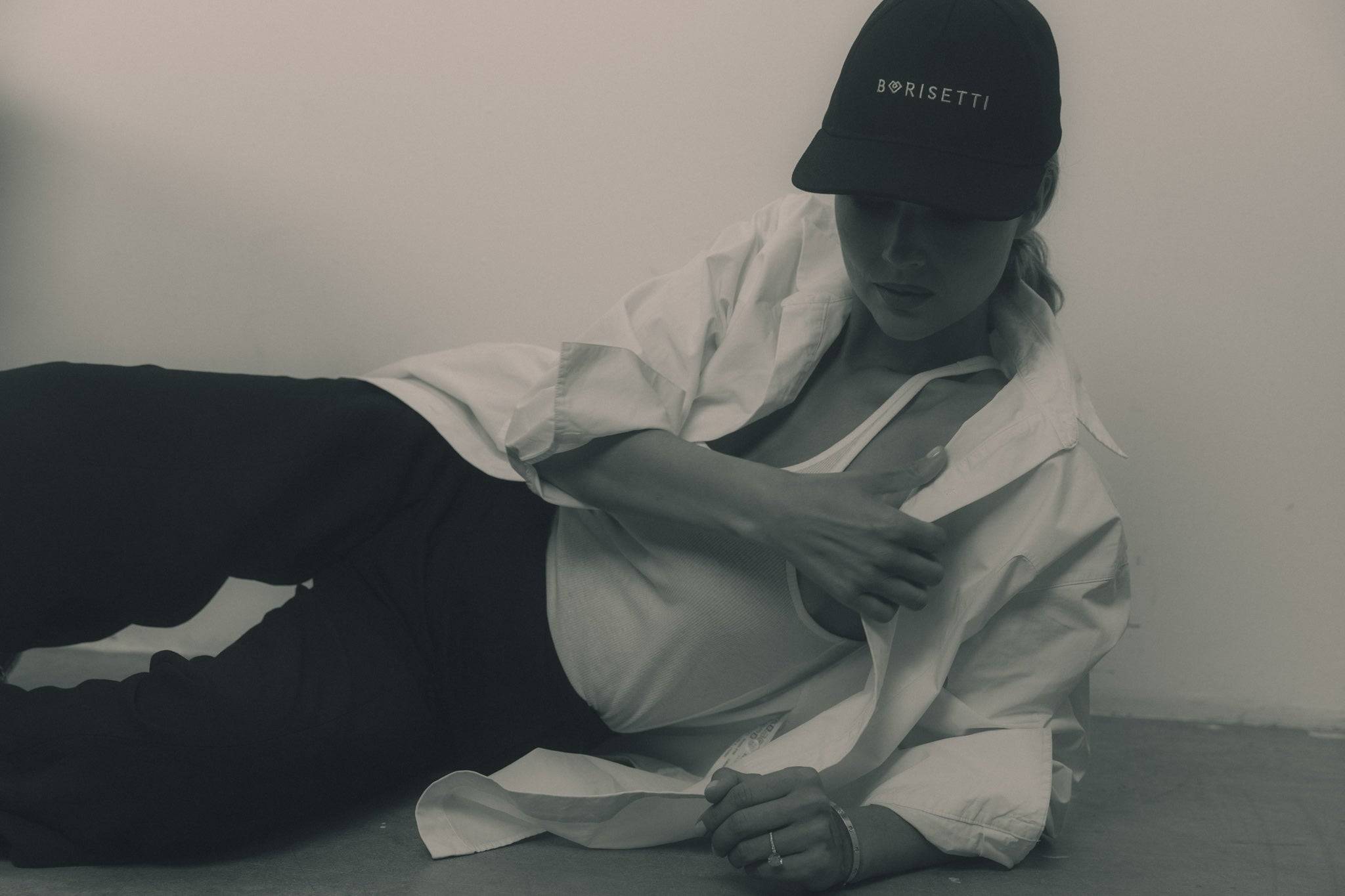 Casual black denim baseball cap styled with a white tank top and oversized shirt, creating a laid-back yet sophisticated look. A must-have for everyday wear.