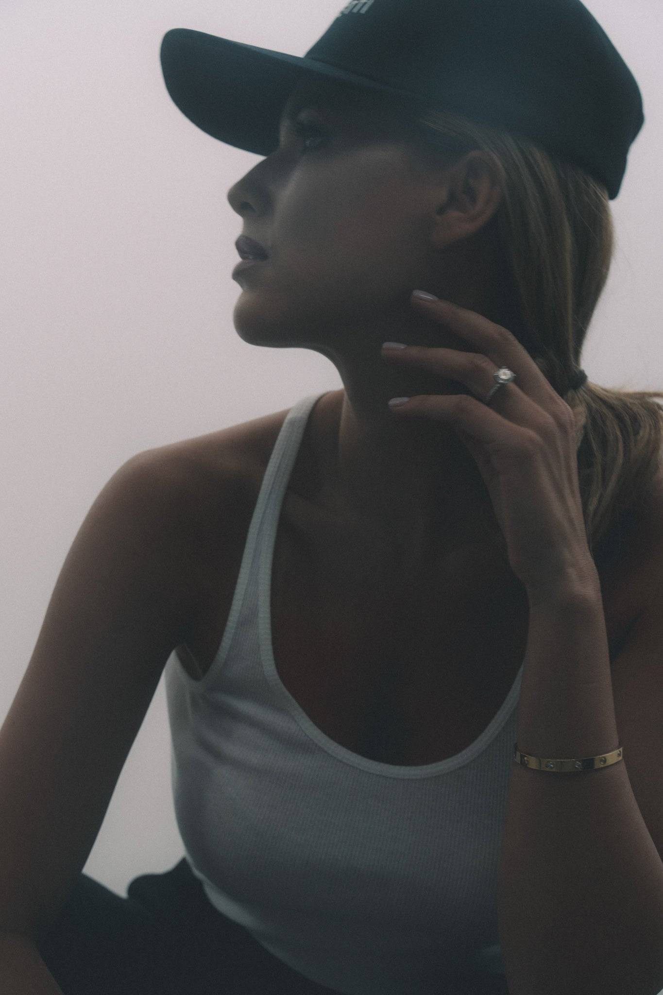 Black denim baseball cap with embroidered Borisetti logo, styled with a white tank top for a casual, minimalist look. A versatile accessory for everyday fashion.
