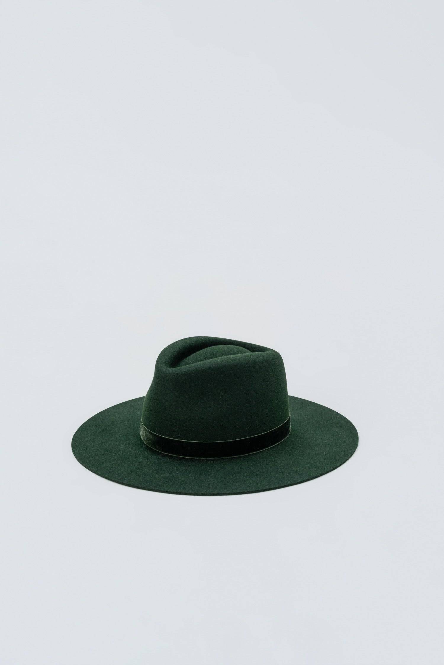 Dark green fedora hat made from rabbit fur felt, featuring a wide brim and a velvet ribbon trim for a sophisticated look.